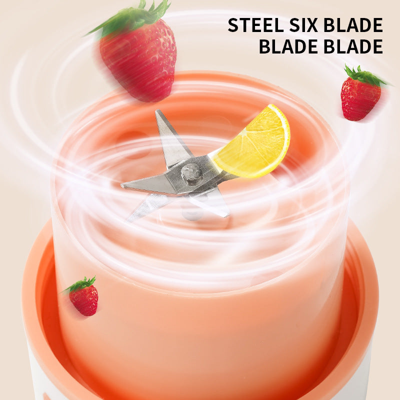 Blender with a steel six blade and strawberry and lemon decorations on a beige background